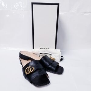 Gucci Black Mules with Gold Emblem
